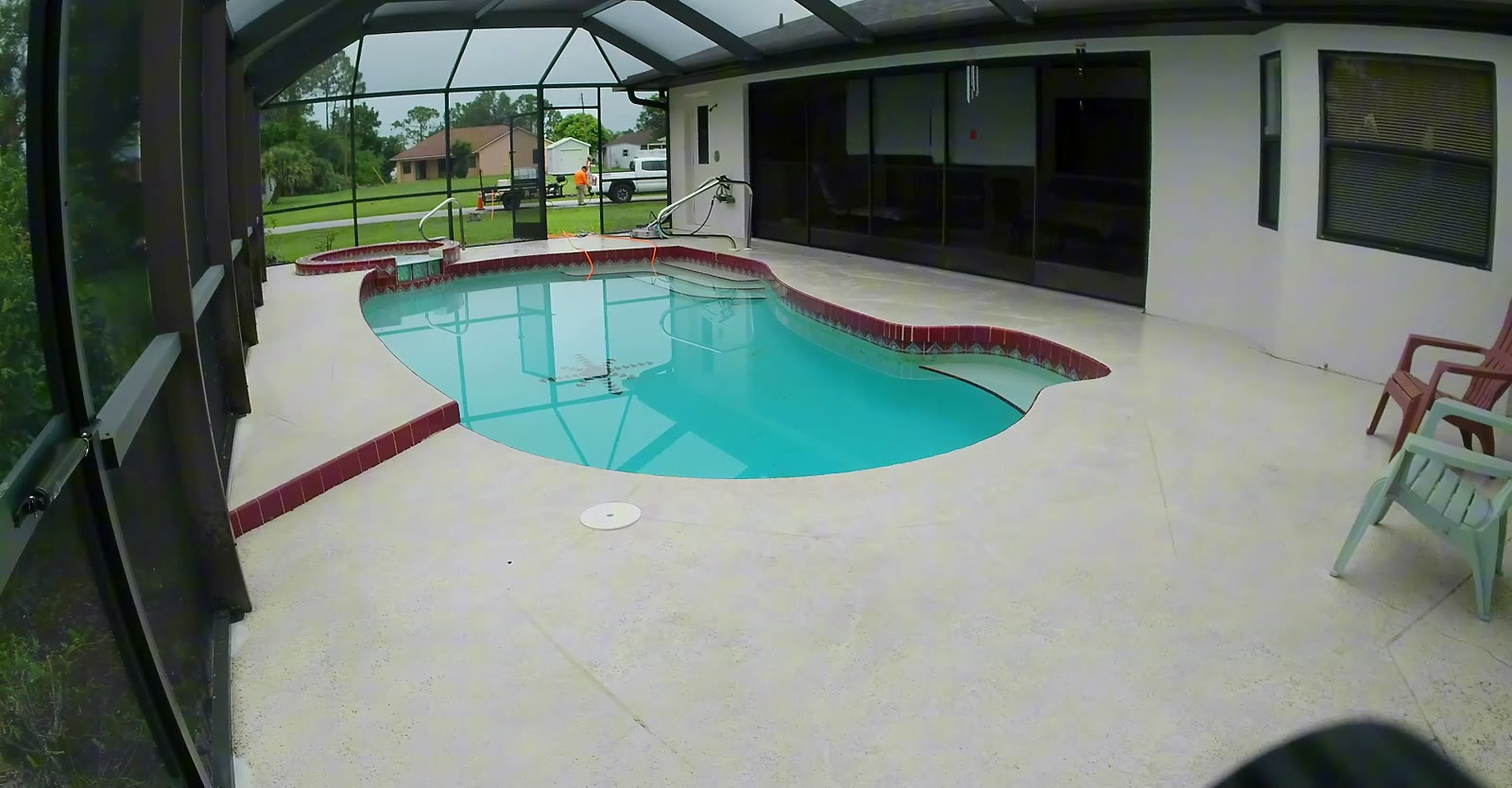 Felix running a 20-inch surface cleaner across pool deck pavers